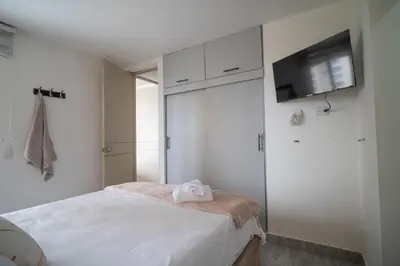 a bedroom with a bed and a flat screen tv at Aqualina 209 y 512 in Cartagena de Indias