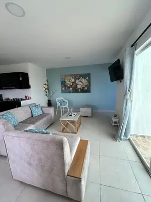 a living room with a couch and a table at Acogedor apartamento con súper ubicación in Barranquilla