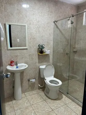a bathroom with a shower and a toilet and a sink at Acogedor apartamento con súper ubicación in Barranquilla