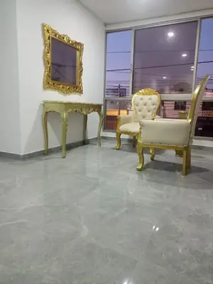a living room with two chairs and a mirror at Hotel La Dorada Sincelejo in Sincelejo