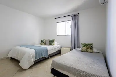 a bedroom with two beds and a window at Caribbean Paradise - Apartamento con salida directa a la playa in Cartagena de Indias