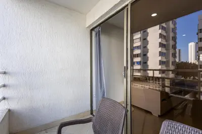 a balcony with a chair and a window at Caribbean Paradise - Apartamento con salida directa a la playa in Cartagena de Indias