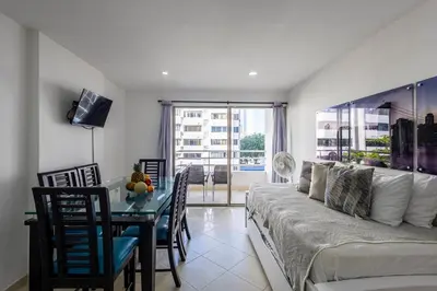 a living room with a couch and a table at Caribbean Paradise - Apartamento con salida directa a la playa in Cartagena de Indias
