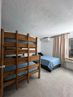 a bedroom with a bed and a bunk bed at White House in Cartagena de Indias