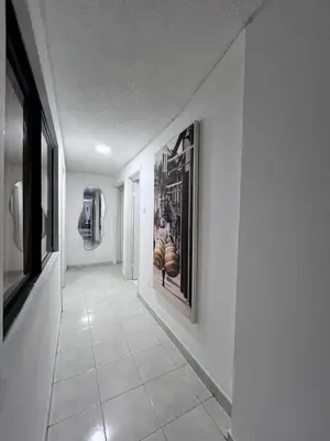 a hallway with white walls and a picture on the wall at White House in Cartagena de Indias