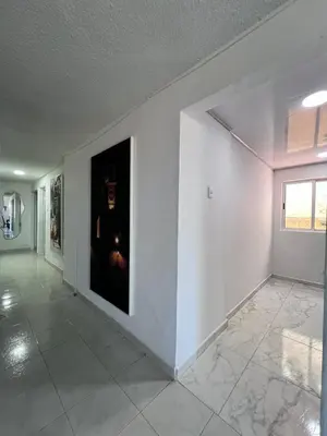 an empty room with a large painting on the wall at White House in Cartagena de Indias