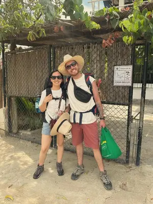 a man and woman standing in front of a gate at Casa Grulla in Santa Marta