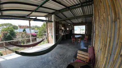 a room with a hammock in a house at Casa Grulla in Santa Marta