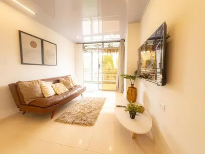 a living room with a couch and a table at CALA Estancias Urbanas, Apartamentos & Suites in Barranquilla