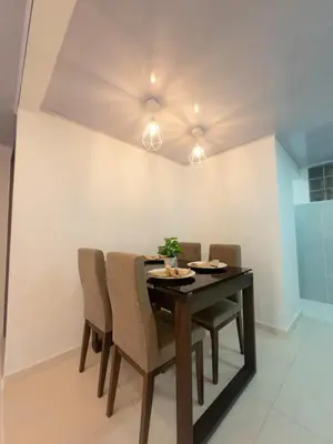 a dining room with a table and chairs at CALA Estancias Urbanas, Apartamentos & Suites in Barranquilla