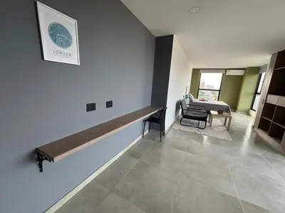 a living room with a bench on the wall at Delux Suite Coral Tower in Barranquilla