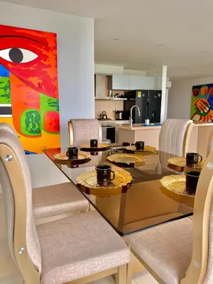 a dining room with a glass table and chairs at Karibmed Cartagena in Cartagena de Indias
