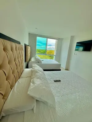 a bedroom with a large bed with a large window at Karibmed Cartagena in Cartagena de Indias
