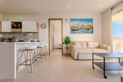 a kitchen and living room with a couch and a table at Cartagena getaway - Laguna Cristalina - 2BR - 7 pax in Cartagena de Indias