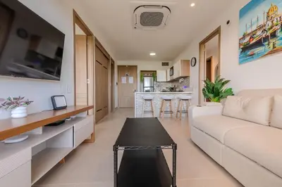 a living room with a couch and a table at Cartagena getaway - Laguna Cristalina - 2BR - 7 pax in Cartagena de Indias