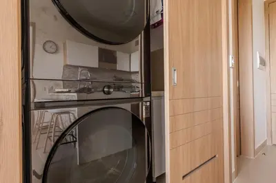a kitchen with a oven and a clock on a wall at Cartagena getaway - Laguna Cristalina - 2BR - 7 pax in Cartagena de Indias