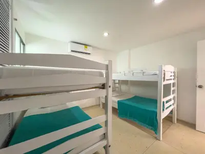 a bunk bed room with two bunk beds in it at Caribbean Sunset - Apartamento con salida a la playa in Cartagena de Indias