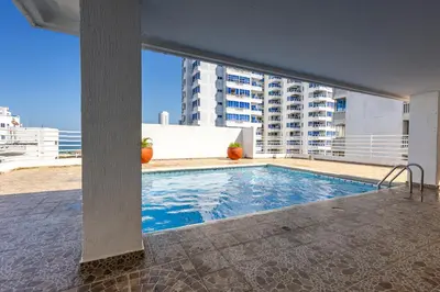a swimming pool on the roof of a building at Caribbean Sunset - Apartamento con salida a la playa in Cartagena de Indias