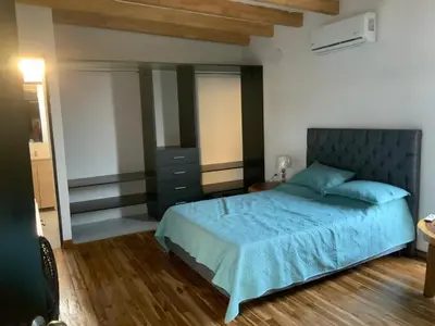 a bedroom with a bed with a blue comforter at Habitacion doble en Villakite ,Salinas del Rey in Juan de Acosta