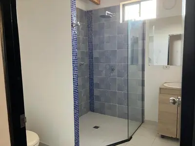 a bathroom with a shower with a toilet and a sink at Habitacion doble en Villakite ,Salinas del Rey in Juan de Acosta