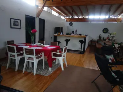 a dining room with a red table and chairs at Habitacion doble en Villakite ,Salinas del Rey in Juan de Acosta