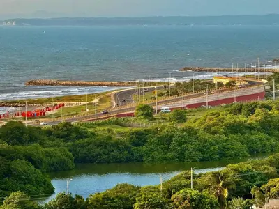 a bridge over a river next to a body of water at Modern Apartment with Ocean Views in Cartagena de Indias