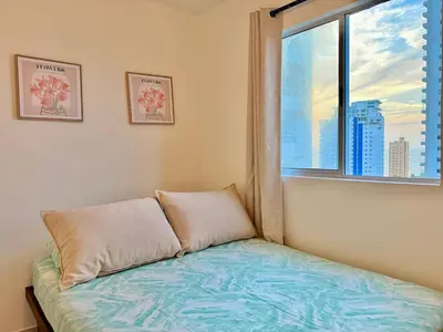 a bedroom with a bed and a window with a view at Modern Apartment with Ocean Views in Cartagena de Indias