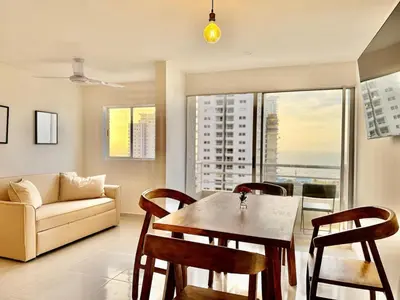 a living room with a table and chairs and a couch at Modern Apartment with Ocean Views in Cartagena de Indias
