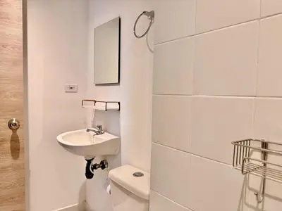 a white bathroom with a sink and a toilet at Modern Apartment with Ocean Views in Cartagena de Indias