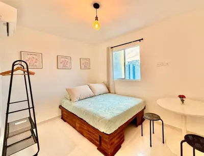 a room with a bed with a ladder and a table at Modern Apartment with Ocean Views in Cartagena de Indias