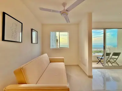 a living room with a couch and a ceiling fan at Modern Apartment with Ocean Views in Cartagena de Indias
