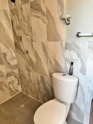 a bathroom with a white toilet in a room at Casa finca platanales in Cartagena de Indias