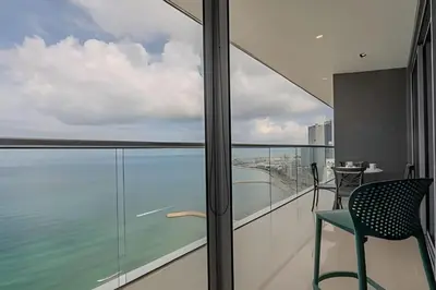 a room with a balcony with a table and a chair at 