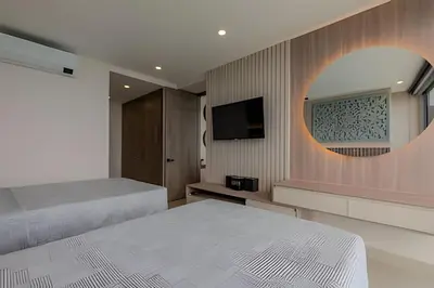 a bedroom with two beds and a flat screen tv at 