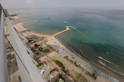 an aerial view of a beach and the ocean at 