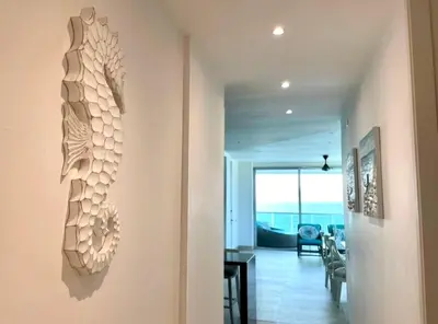 a hallway with a living room and a dining room at 3BR AC Amazing View and Pool, Best sunset ever in Coveñas