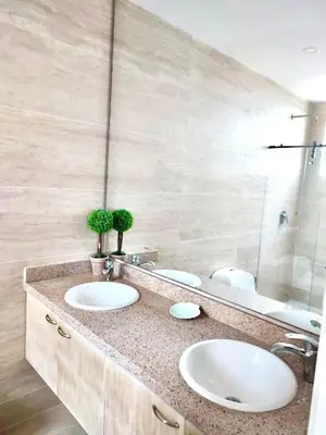 a bathroom with two sinks and a large mirror at 3BR AC Amazing View and Pool, Best sunset ever in Coveñas