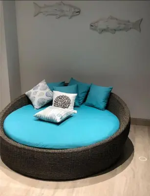 a wicker circular couch with pillows on top of it at 3BR AC Amazing View and Pool, Best sunset ever in Coveñas