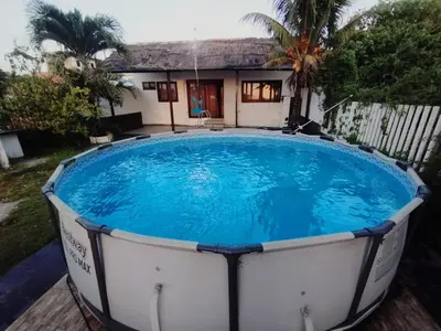 a large swimming pool in front of a house at La Cabana de Isaac Boquilla in Cartagena de Indias