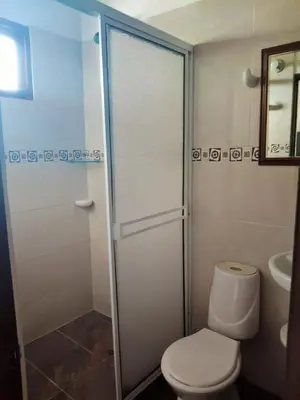 a bathroom with a toilet and a glass shower at La Cabana de Isaac Boquilla in Cartagena de Indias