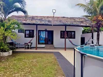 a villa with a swimming pool and a house at La Cabana de Isaac Boquilla in Cartagena de Indias