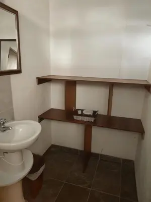 a bathroom with a sink and a toilet and a mirror at La Cabana de Isaac Boquilla in Cartagena de Indias