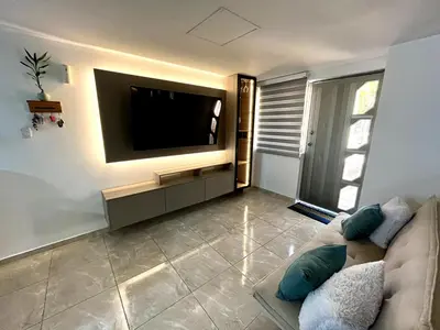 a living room with a couch and a flat screen tv at Moderno apartamento privado con parqueadero in Barranquilla