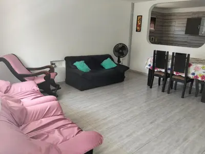 a living room with a black couch and chairs at La casa de la abuela cartagena in Cartagena de Indias