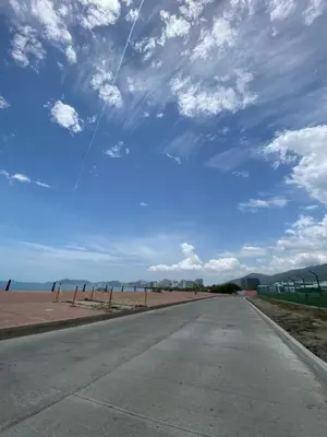 an empty road on the beach with a cloudy sky at Palmar in Playa Dormida