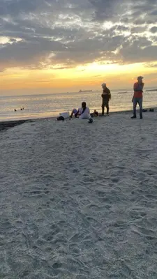 a group of people standing on a beach at Palmar in Playa Dormida