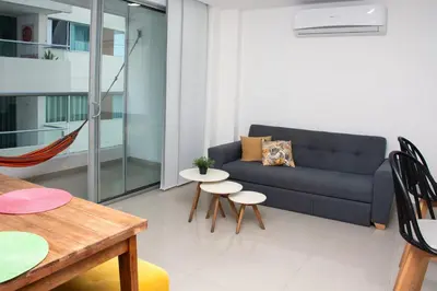 a living room with a couch and a table at Hermoso Apartamento con Piscina 1 Habitacion CMC66 in Cartagena de Indias