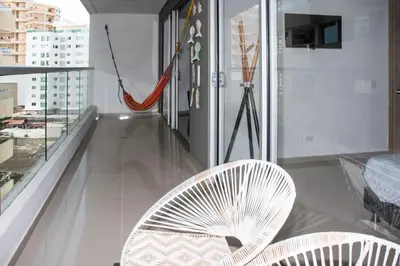a room with two white chairs and a balcony at Hermoso Apartamento con Piscina 1 Habitacion CMC66 in Cartagena de Indias