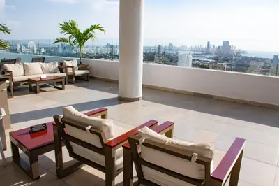 a balcony with a table and chairs on a building at Hermoso Apartamento con Piscina 1 Habitacion CMC66 in Cartagena de Indias