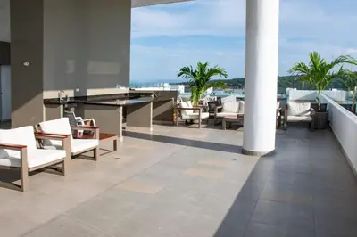 a balcony with chairs and a pool table on a building at Hermoso Apartamento con Piscina 1 Habitacion CMC66 in Cartagena de Indias